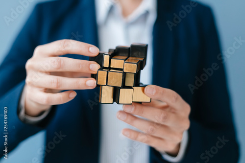 Young woman trying her skills with a magic cube photo