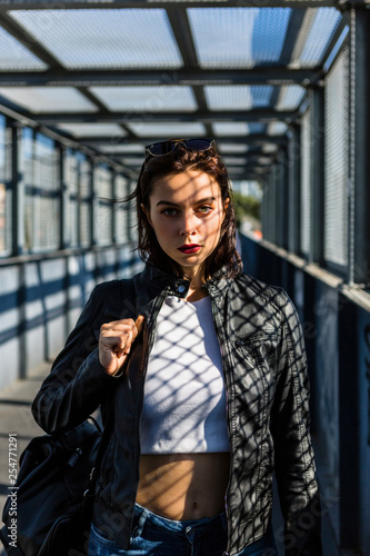 Portrait of young woman standing on a bridge