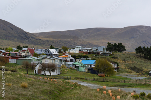 village in the mountains, brown hills, foggy weather