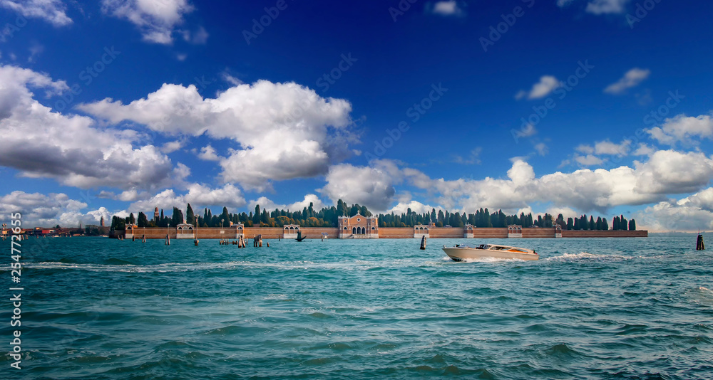 Beautiful view of old cemetery on island in Venice, Italy. There is a beautiful clear sea and beautiful clouds