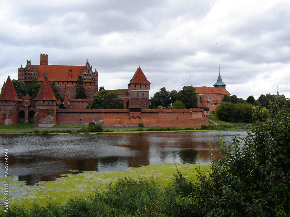 Teutonic castle in Malbork with reflection in Nogat river. Poland.