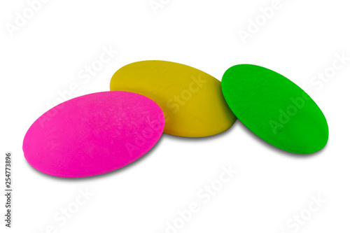 Pink, yellow and green color soft erasers, isolated on white background