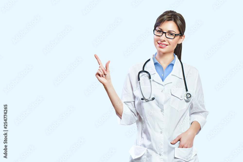 Friendly smiling young female doctor. hand pointing at copy space Friendly smiling young female doctor. hand pointing at copy space
