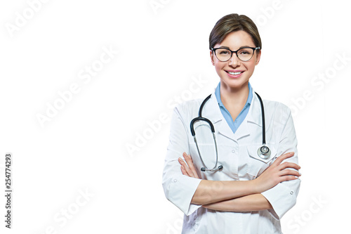 Portrait of glad smiling doctor in white uniform standing with crossed hands isolated on white background