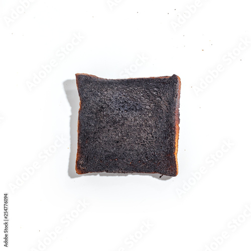 Burnt charred Sliced toast bread isolated on white background. Top view.