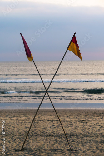 No swimming flags at dusk on beach
