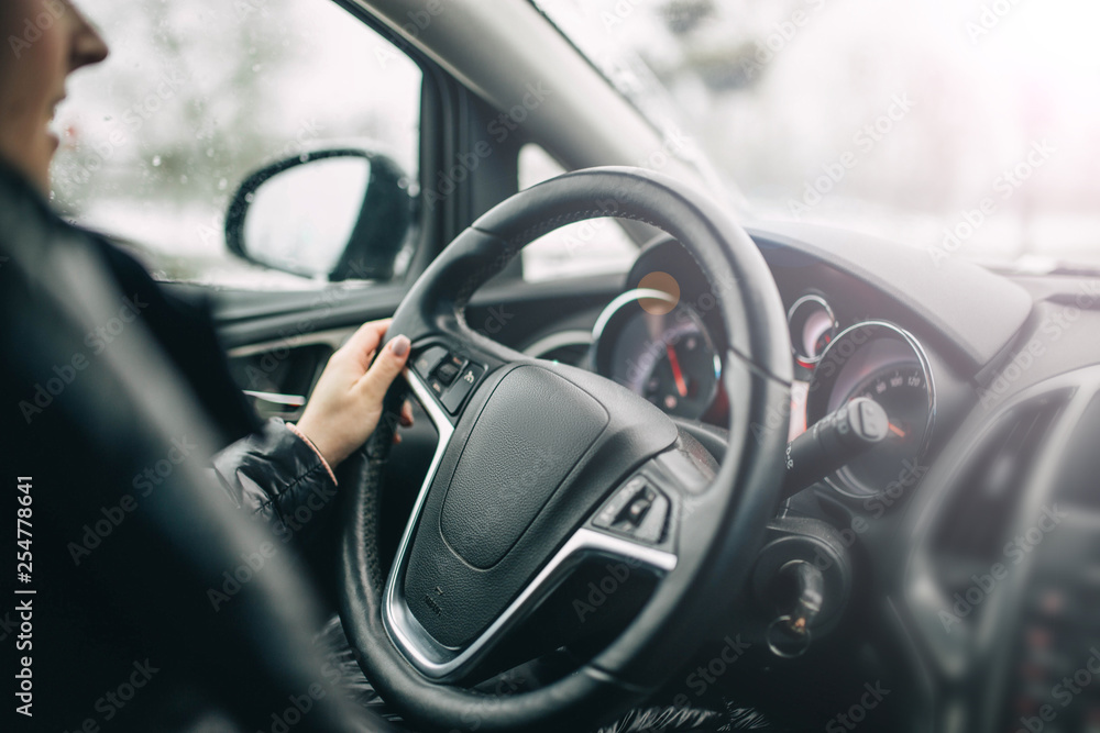 Female car driver rides on a sunny day. Travel concept