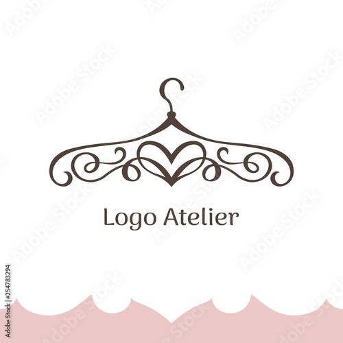 Logo for Atelier, wedding boutique, women's dress shop. Vector template of the brand for the fashion designer. Stylized clothes hanger made of twisted lines and heart photo