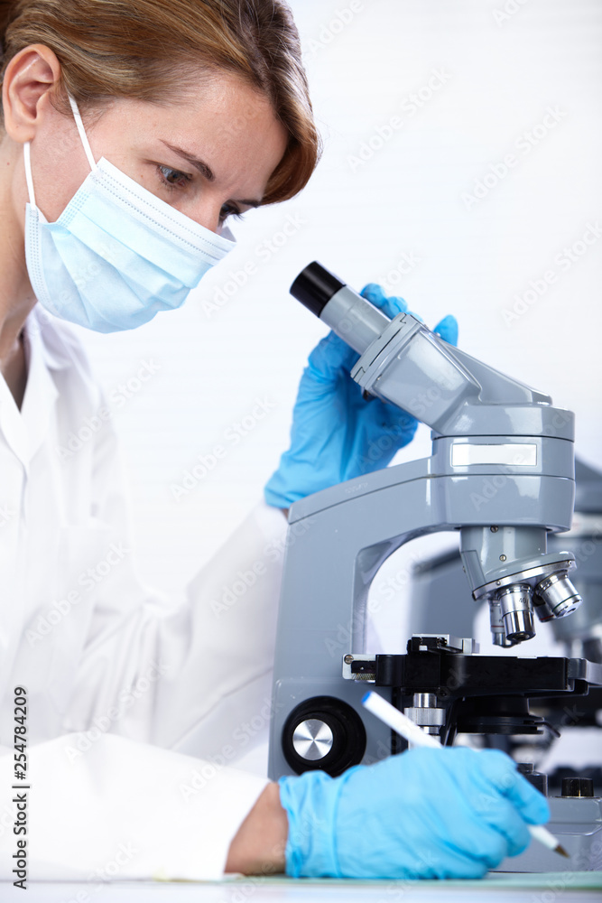 scientist working with microscope scientist working with microscope