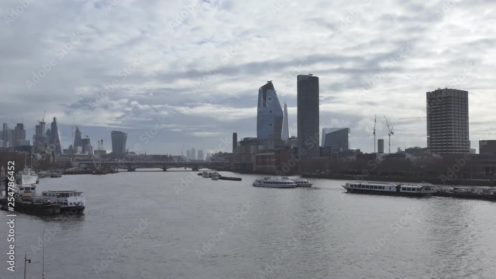 The Thames river with high-rise buildings in the background. The Thames river with high-rise buildings in the background.
