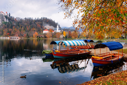 Beautiful landscape of Bled Lake and Pletna boats photo