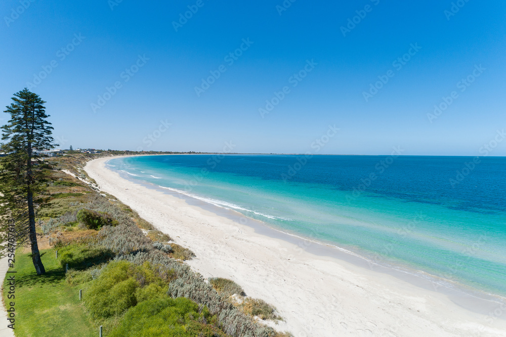 Aerial view over sandy white beach in summer with stunning turquoise blue ocean Aerial view over sandy white beach in summer with stunning turquoise blue ocean