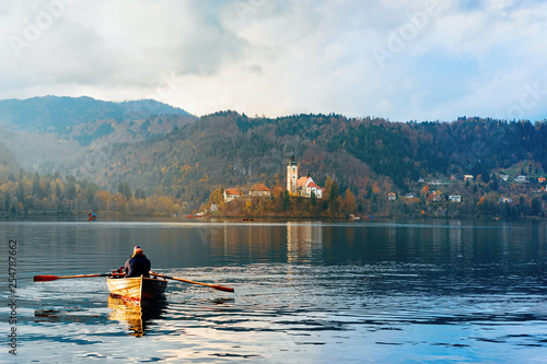 Beautiful landscape with people in boat in Bled Lake photo