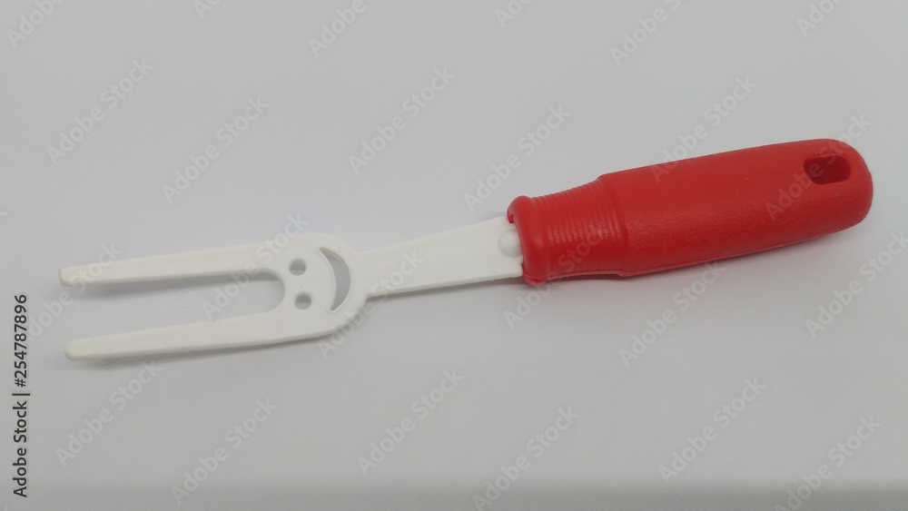 white toy fork with a smiling face white toy fork with a smiling face