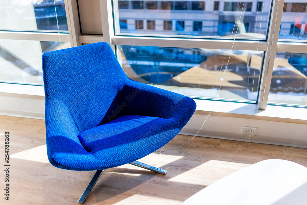 New modern office room in building with vibrant blue chair closeup by glass  window with corporate view and wooden floor Stock Photo | Adobe Stock