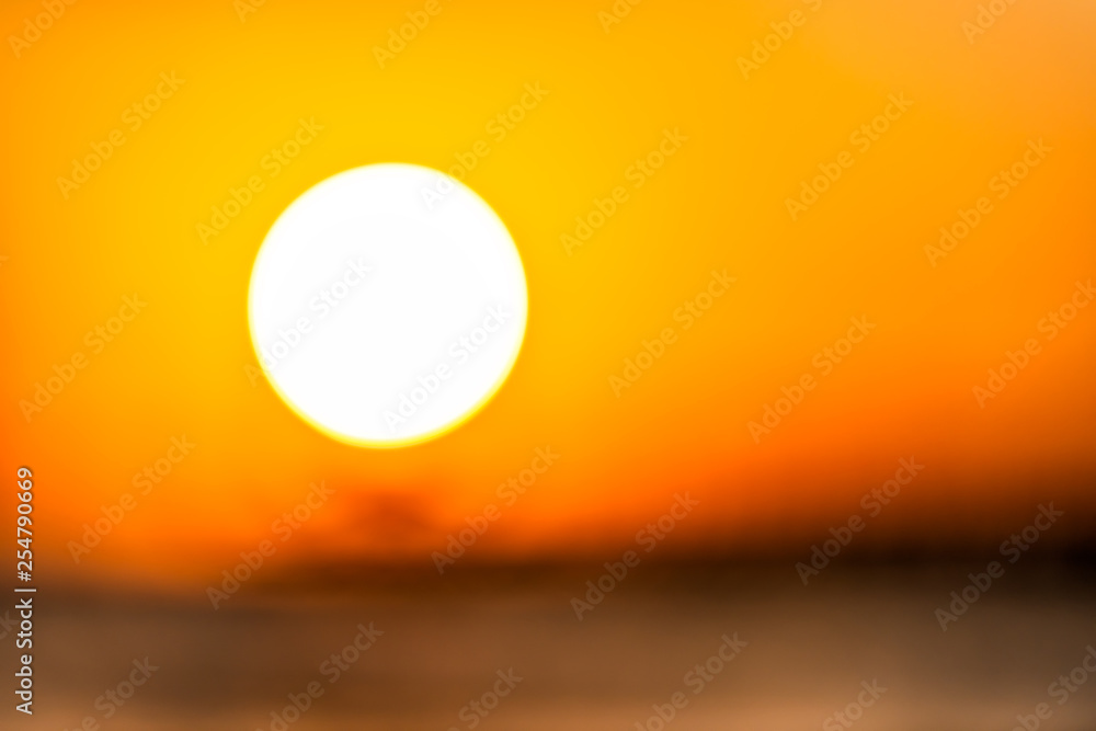 Bokeh blurry background abstract closeup of sun in Naples, Florida with orange sunset in gulf of Mexico and pier landscape on horizon Bokeh blurry background abstract closeup of sun in Naples, Florida with orange sunset in gulf of Mexico and pier landscape on horizon
