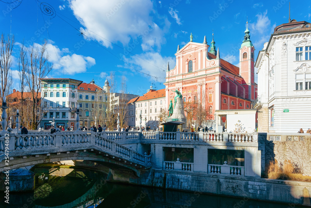 People at Franciscan Church and Triple Bridge Ljubljanica River Ljubljana