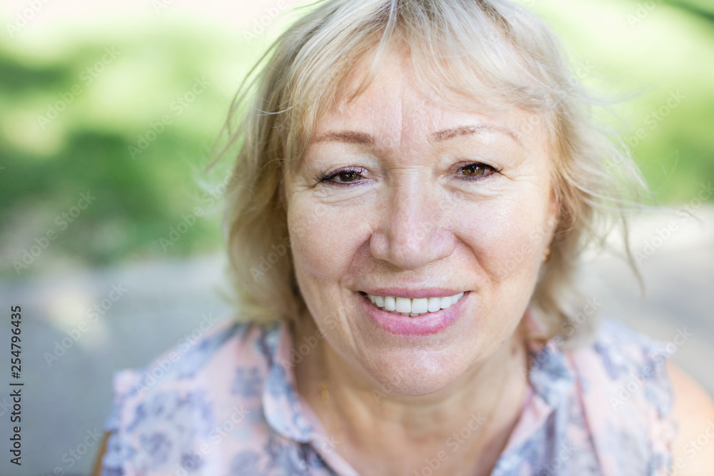 Portrait of happy mature woman outdoors Portrait of happy mature woman outdoors