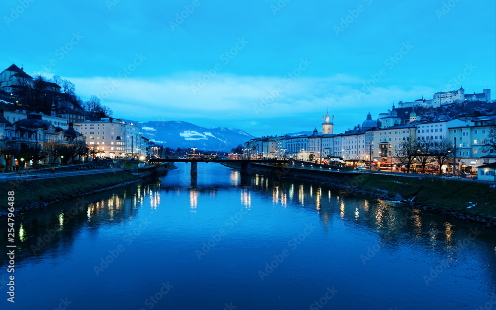 Naklejka premium Old town and Hohensalzburg castle at Salzach River Salzburg evening
