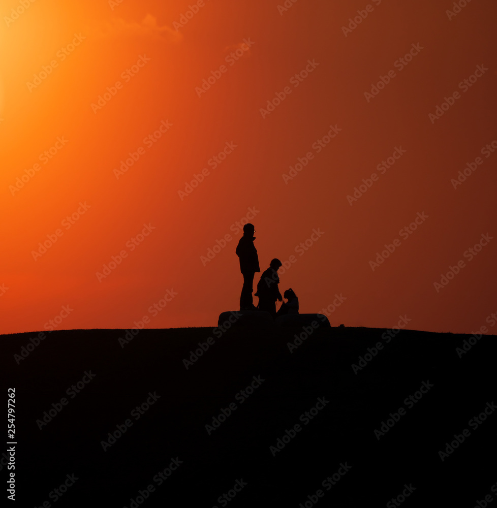 Tokyo,Japan-March 12, 2019: A silhouette of people on a hill at sunset