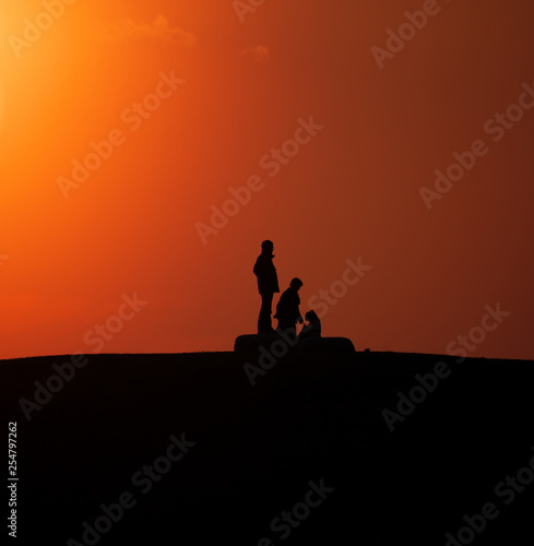 Tokyo,Japan-March 12, 2019: A silhouette of people on a hill at sunset © Khun Ta