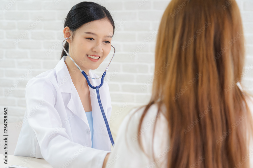 Female doctor talking to patient.Doctor and patient discussing something while sitting at the table . Medicine and health care concept. Doctor and patient Female doctor talking to patient.Doctor and patient discussing something while sitting at the table . Medicine and health care concept. Doctor and patient