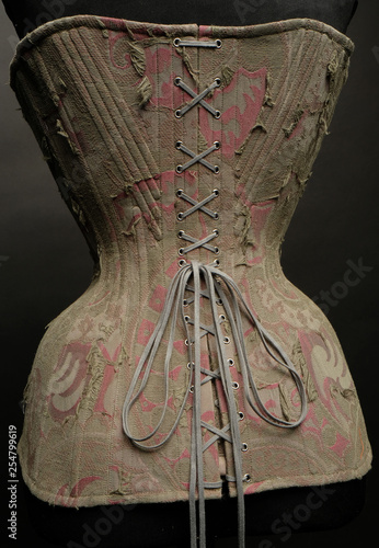 Fototapeta Naklejka Na Ścianę i Meble -  Closeup of vintage female corset on dark studio background