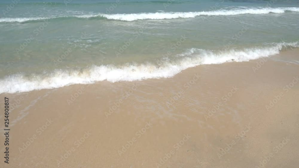 Beach waves water curling into an arched form and breaking on the shore hitting the shore line of beach sand. Beach waves water curling into an arched form and breaking on the shore hitting the shore line of beach sand.