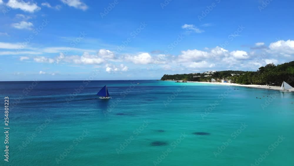 Sail Boat on Turquoise Ocean, Palm Fringed White Sand Beach. Sail Boat on Turquoise Ocean, Palm Fringed White Sand Beach.