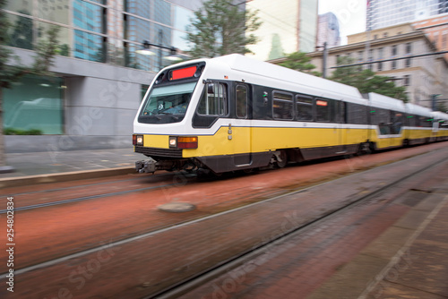 City Train Zooming Through Downtown