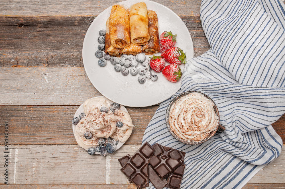 Healthy breakfast, coffee and homemade pancakes with fresh berries on wooden table Healthy breakfast, coffee and homemade pancakes with fresh berries on wooden table