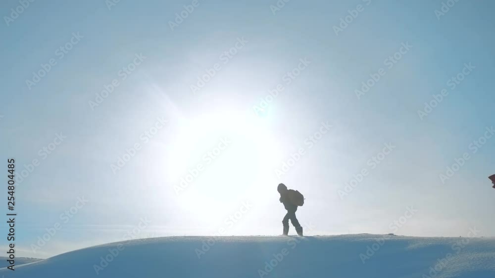 teamwork. men tourists climbing walking top mountains rocks peak group team sunlight silhouette on snow feet winter snow trip. lifestyle slow motion video. people teamwork business travel the teamwork. men tourists climbing walking top mountains rocks peak group team sunlight silhouette on snow feet winter snow trip. lifestyle slow motion video. people teamwork business travel the