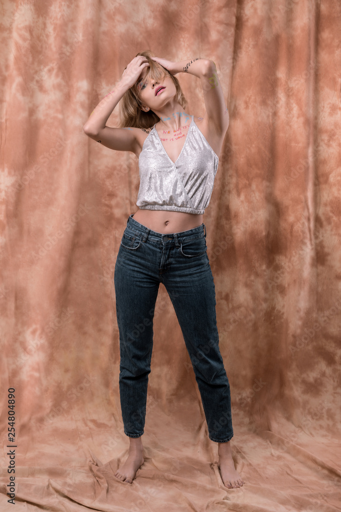 Attractive magnetic young woman touching her hair Attractive magnetic young woman touching her hair