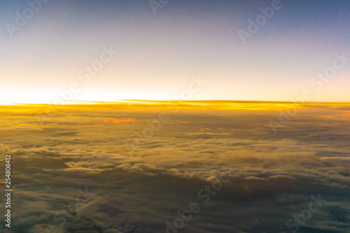 Colorful sunrise sky with cloud above view from airplane