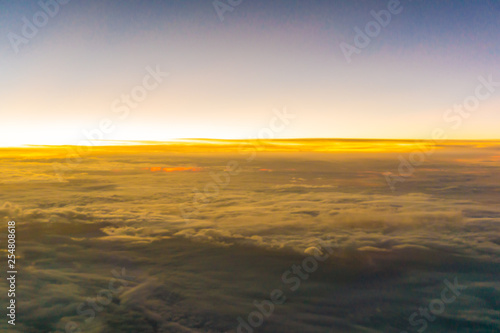 Colorful sunrise sky with cloud above view from airplane