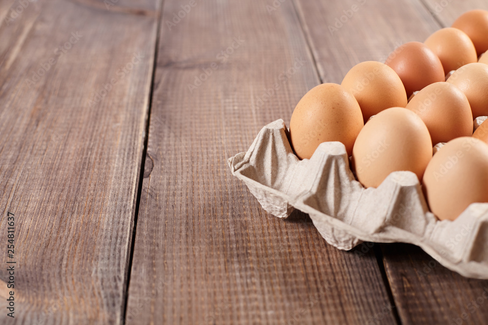 A pack of eggs on wooden table. A pack of eggs on wooden table.
