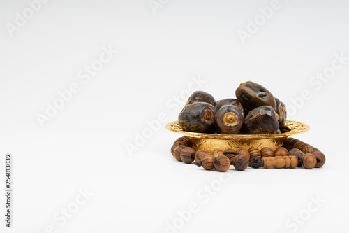 Dates and Rosary on white background with selective focus and crop fragment. Ramadan, Religion and Copy space concept. Black and White