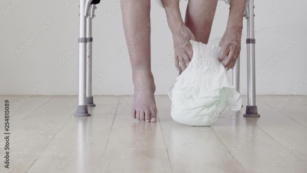 elderly woman changing diaper with caregiver Stock ビデオ Adobe Stock
