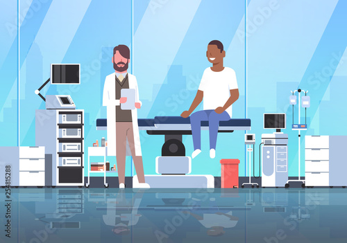 doctor visiting african american man patient sitting on operation table healthcare concept hospital room interior modern equipment medical clinic horizontal full length