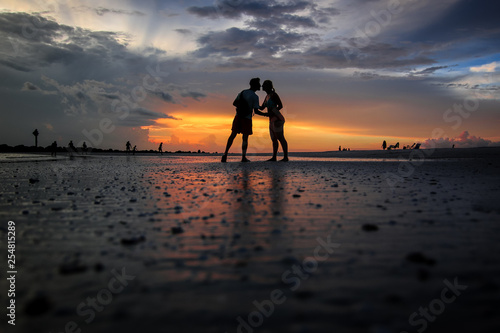Silhouettes of a couple kissing on a beach at Honeymoon Island State Park near Clearwater  Florida