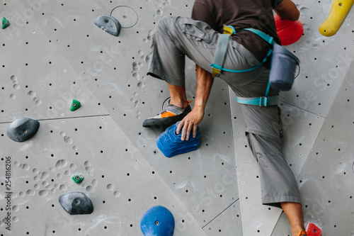 Climber legs in climbing gym
