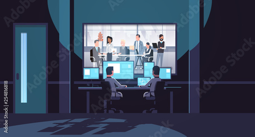 two men looking at monitors behind glass mix race business people team brainstorming meeting conference dark office interior surveillance security system flat horizontal