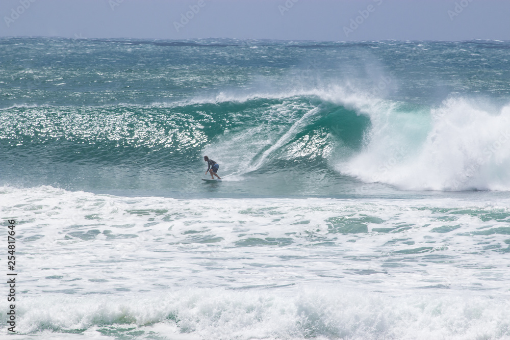 man surfer catching big wave from Kirra beach Coolangatta Queensland Gold Coast Australia cyclone swell man surfer catching big wave from Kirra beach Coolangatta Queensland Gold Coast Australia cyclone swell