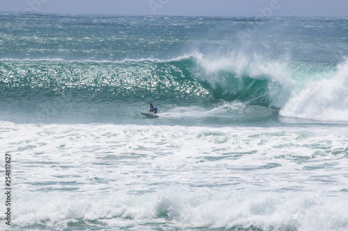 man surfer catching big wave from Kirra beach Coolangatta Queensland Gold Coast Australia cyclone swell