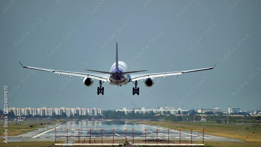 Commercial aeroplane or airliner on a final approaching landing at an International Airport on a clear morning sky Commercial aeroplane or airliner on a final approaching landing at an International Airport on a clear morning sky