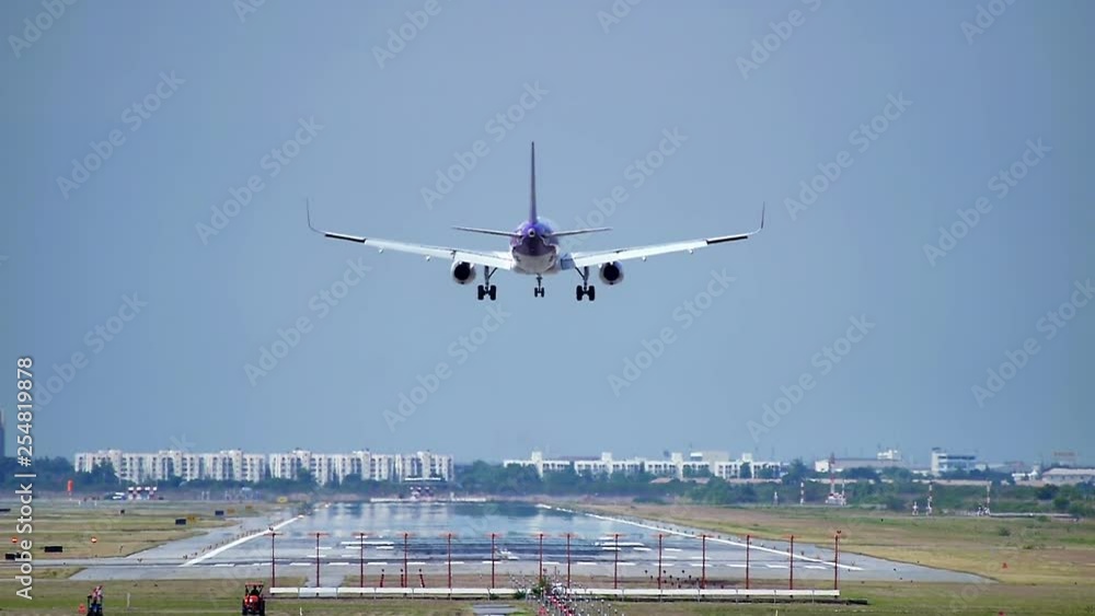 Commercial aeroplane or airliner on a final approaching landing at an International Airport on a clear morning sky