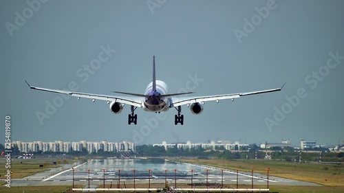 Commercial aeroplane or airliner on a final approaching landing at an International Airport on a clear morning sky