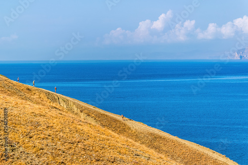 Hill slope against a blue sea photo