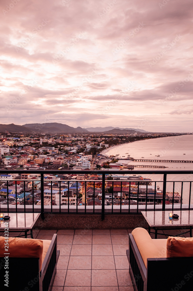 Fototapeta premium Famous Hua Hin beach and bay in evening with cityscape view from hotel sky deck