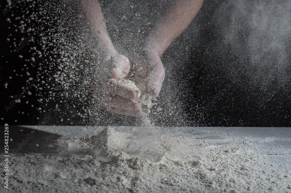 Obraz premium Man prepares a meal of flour